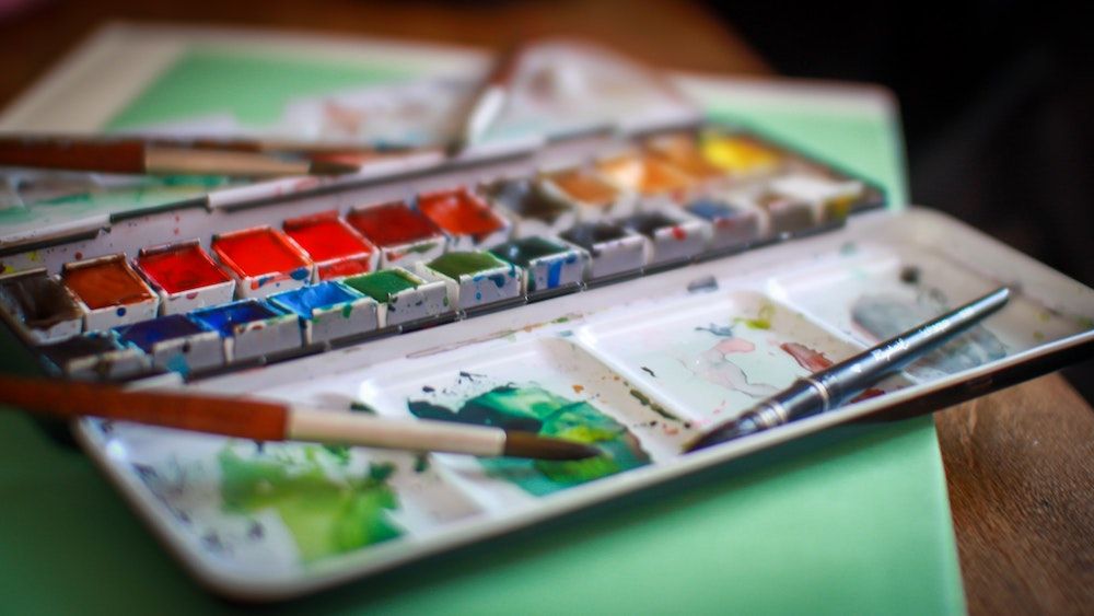 Different types of watercolor paint - tubes, pans, and liquid